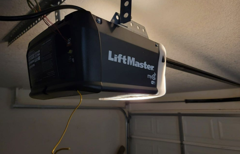 a professional technician installing a garage door opener in Orlando, Florida, showcasing the comprehensive services provided by Orlando FL Quick Garage Door and Gate Repair.