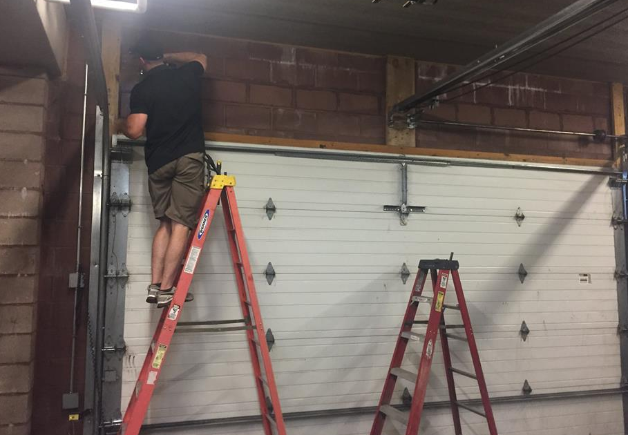 a professional technician from Orlando FL Quick Garage Door and Gate Repair performing a local garage door repair service, emphasizing quality and efficiency.