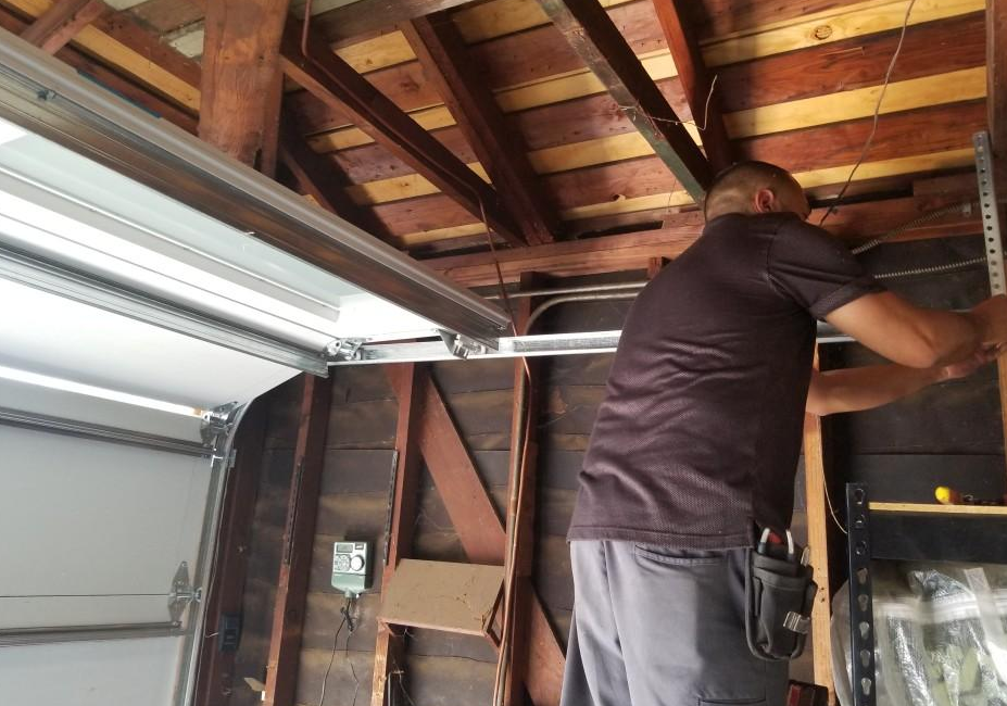 Technician performing garage door track repair in Orlando, FL showcasing precise alignment and expert craftsmanship.