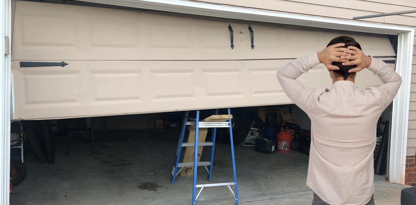Image showing a professional technician repairing a residential garage door with tools, representing the expert services offered by Orlando FL Quick Garage Door and Gate Repair.