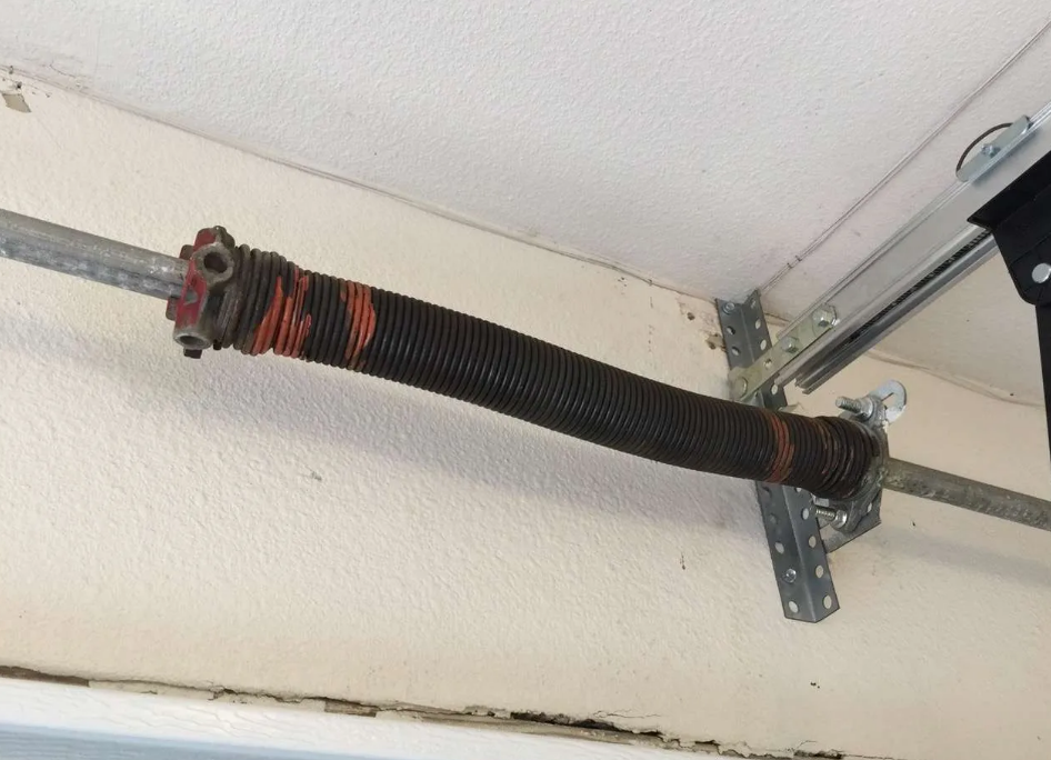 a professional technician performing garage door spring repair at a residential property in Orlando, FL, showcasing expertise from Orlando FL Quick Garage Door and Gate Repair."