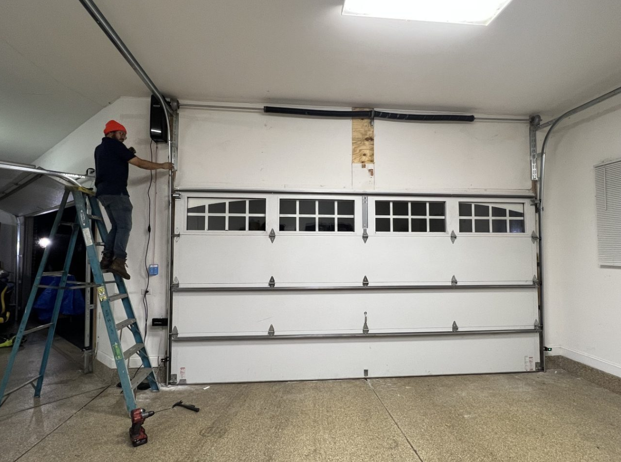 Orlando FL Quick Garage Door and Gate Repair technician working on a residential garage door in Baldwin Park, Florida.